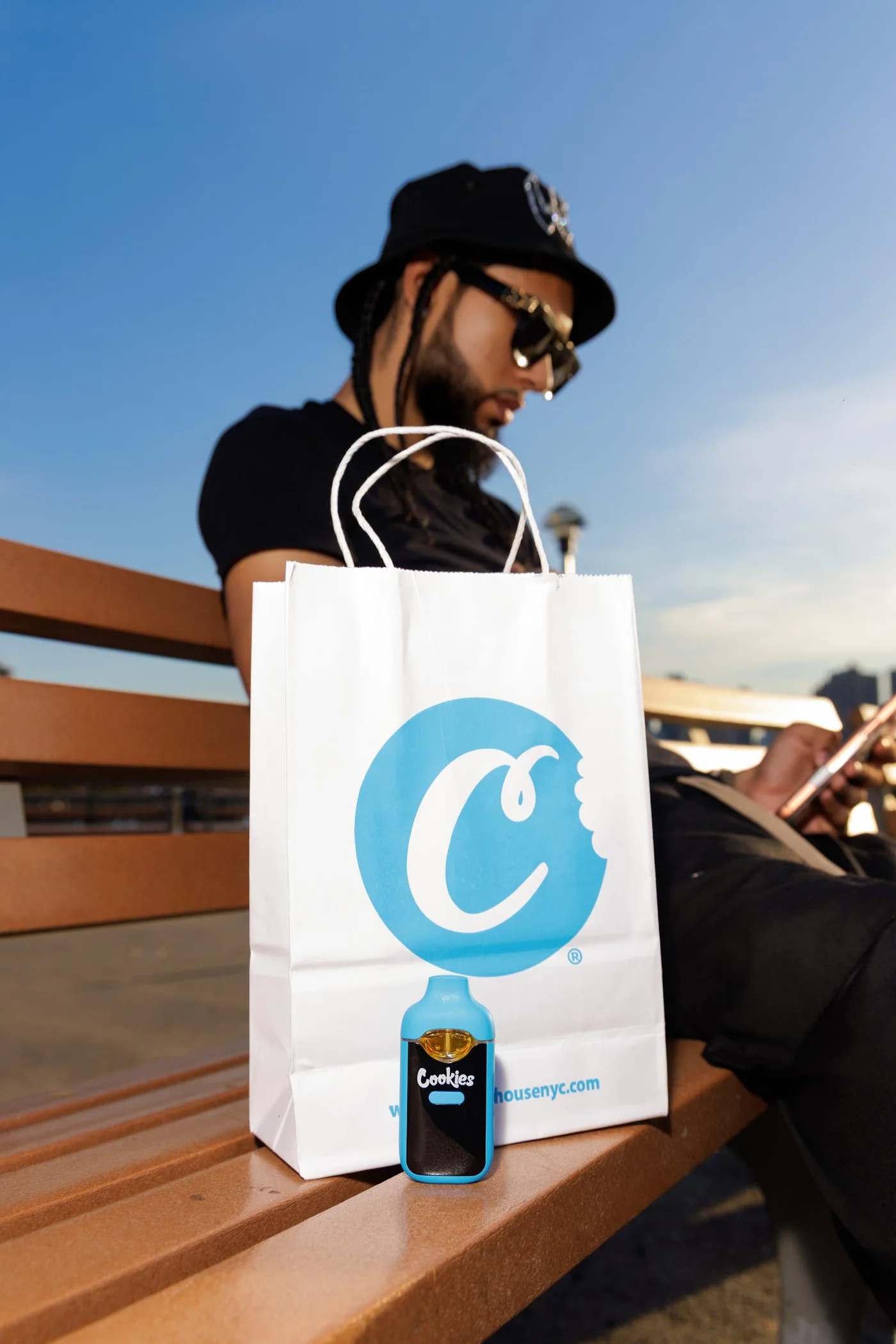 Customer seated beside a Culture House shopping bag in New York