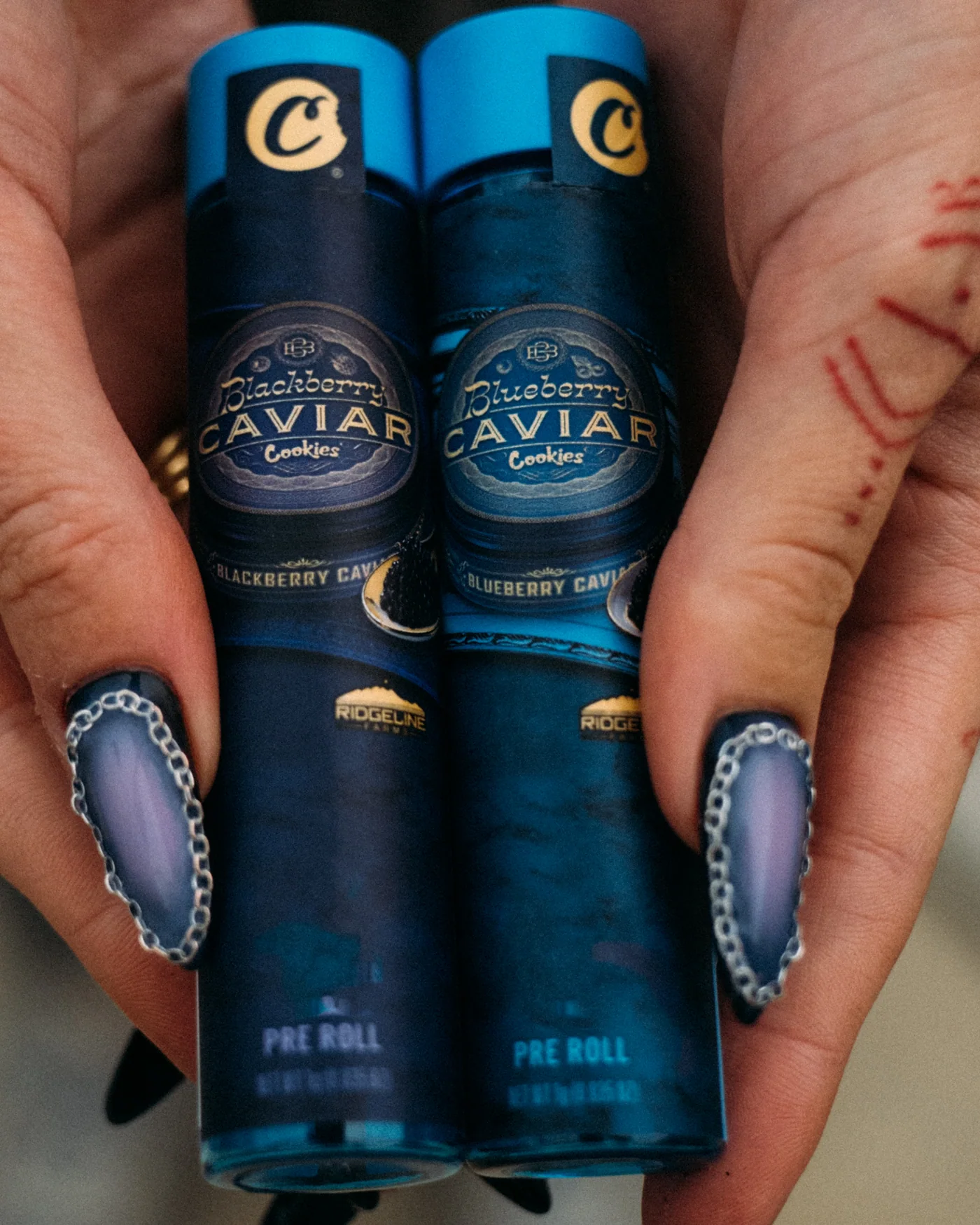 Cookies Caviar pre-rolls held in hand